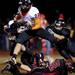 Tecumseh High School senior John Terry hurdles over Milan defenders on Friday. Tecumseh leads at halftime 14-6. Daniel Brenner I AnnArbor.com
